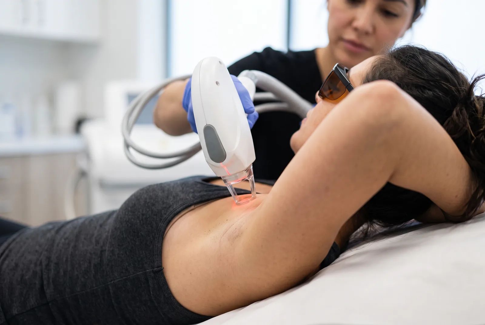 Närbild på ett laserhandstycke mot hud